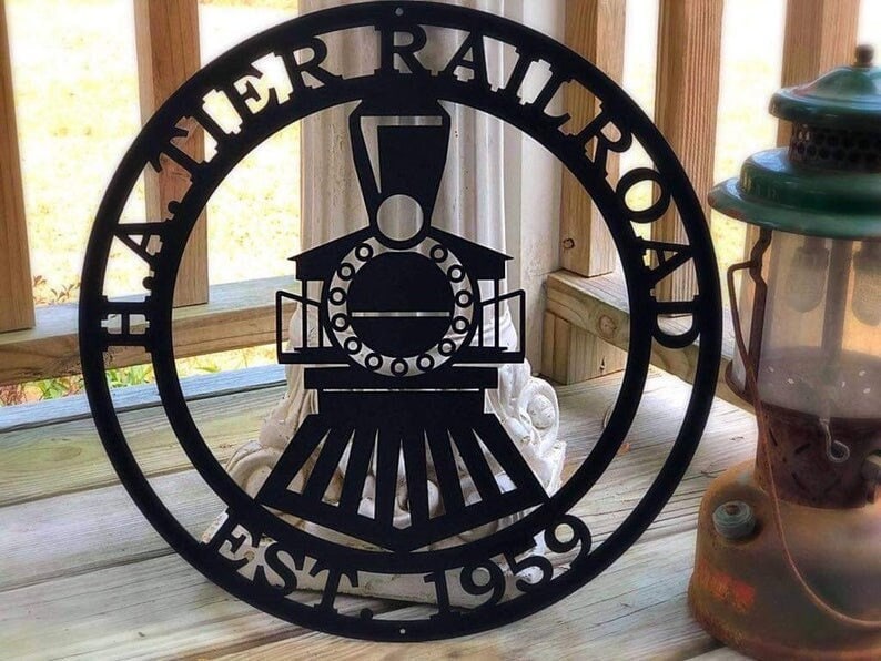 Personalized Metal Train Sign shown with custom text in Black on front porch